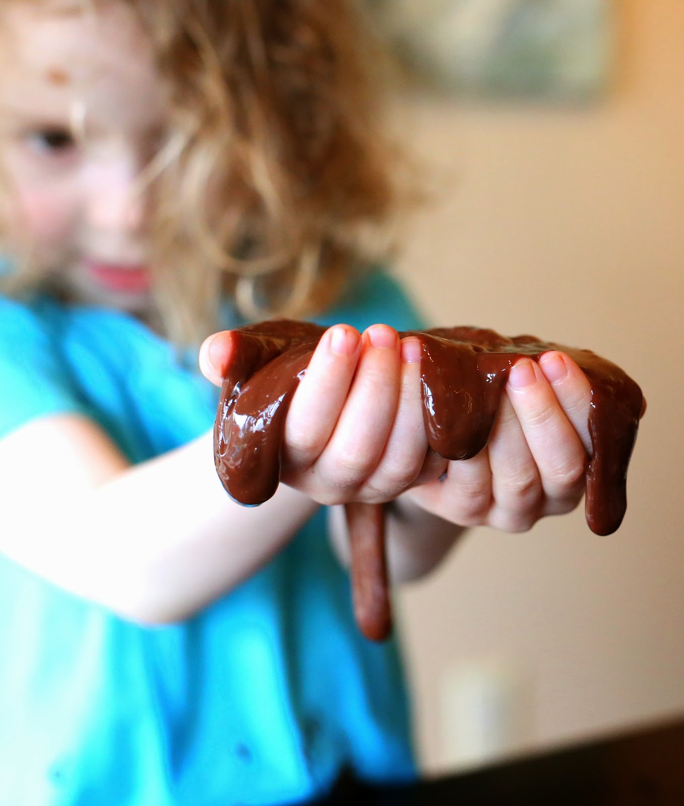 Лизун с ароматом шоколада-тягучая субстанция в руках ребенка
